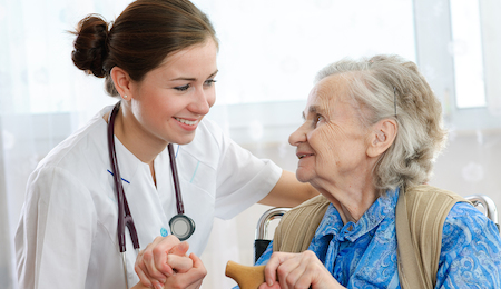 Senior woman with her doctor or caregiver